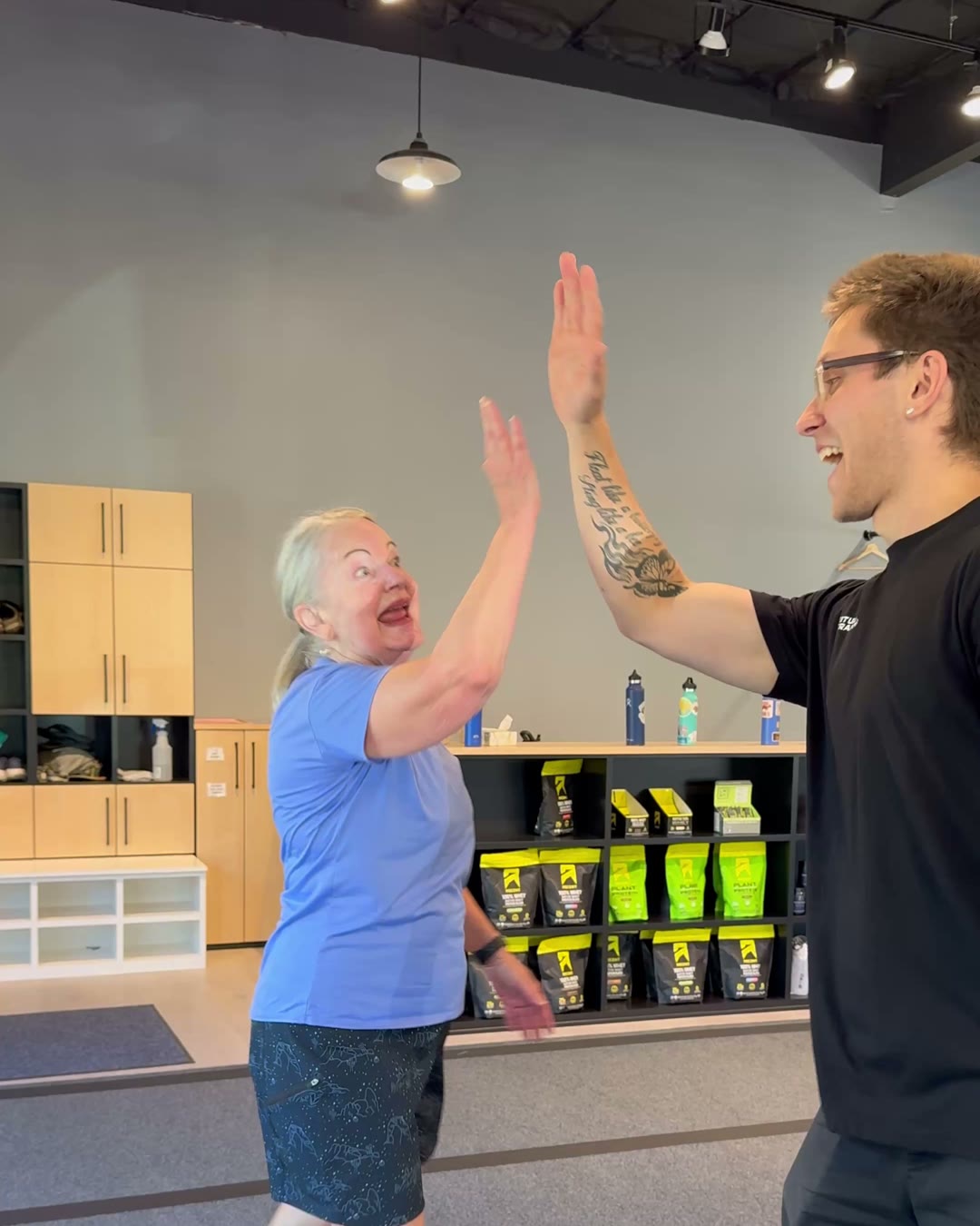 A Ritual Longevity member high-fives her coach after a session